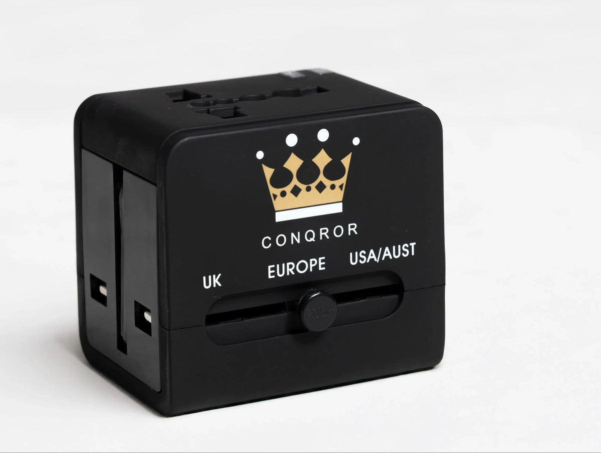 Black travel adapter with UK, European, and USA/Australia plug options - Chargimundo